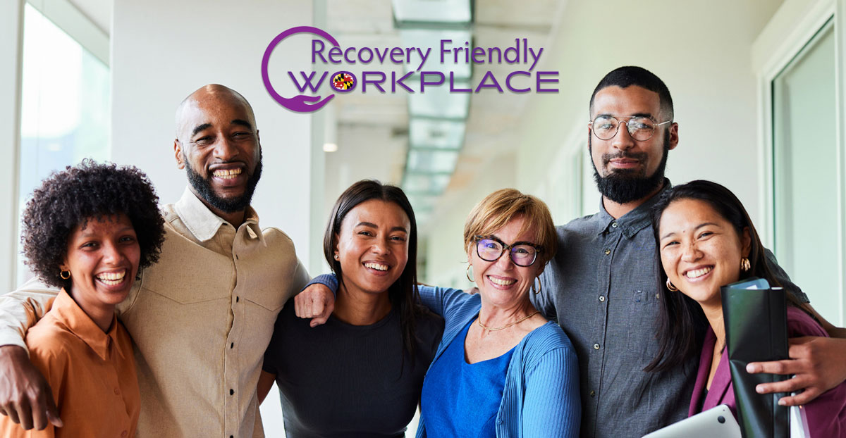 recovery friendly workplace logo and 6 workers stand in an office