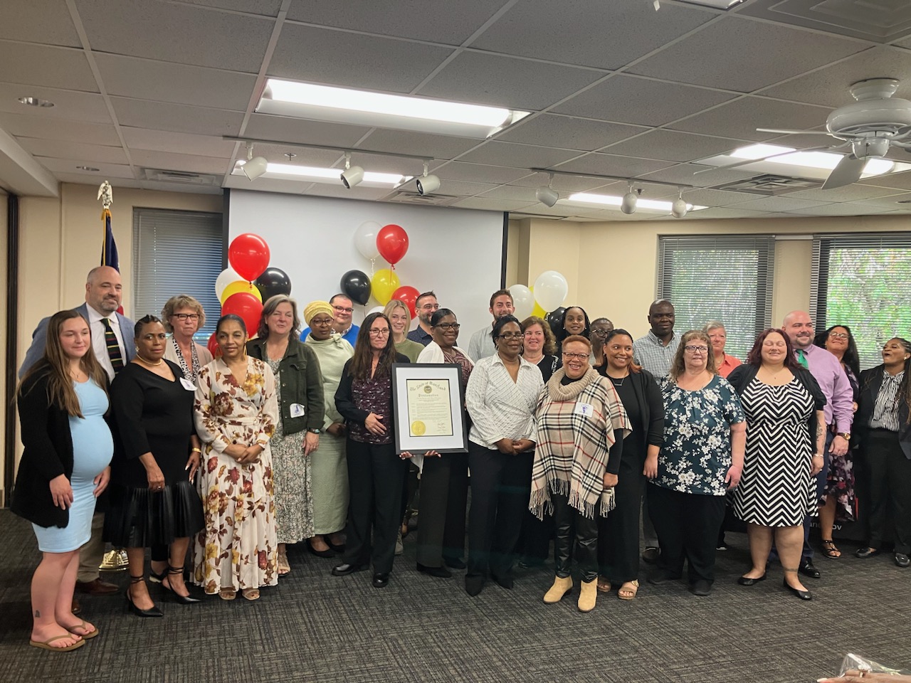 Attendees of the Direct Support Professionals Celebration hold up the citation from Governor Wes Moore.