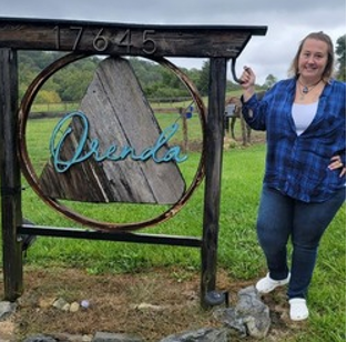 Charlotte outside stands by the Orenda Center of Wellness sign